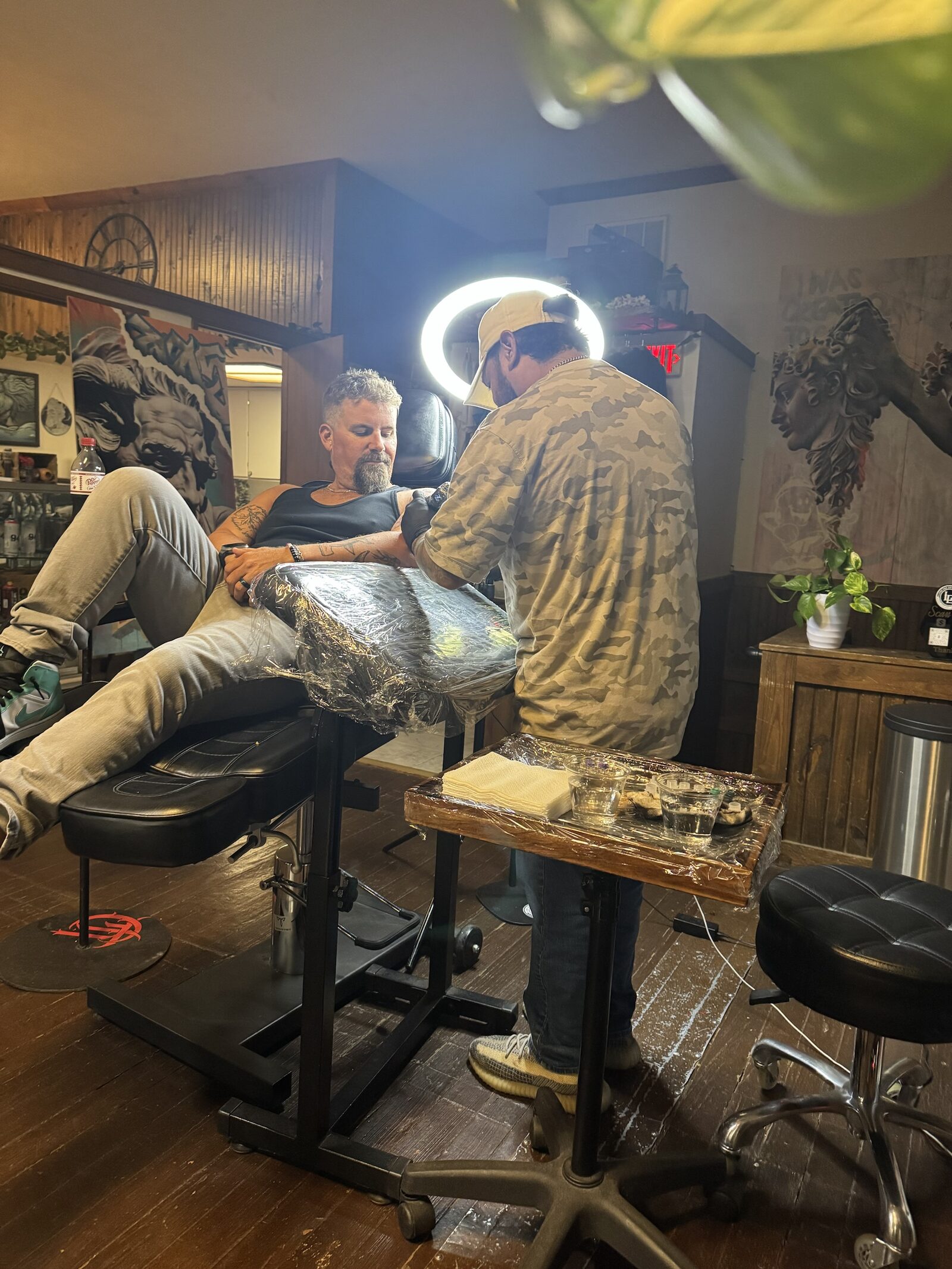 A tattoo session in progress at Lions Den Art Collective in downtown Seguin